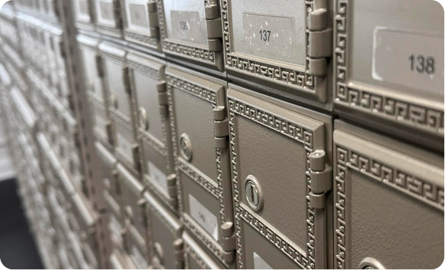 Row of numbered private mailboxes with metal doors and locks